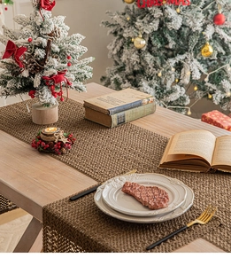 Detail of brown woven Christmas table runner with hollow mesh texture and festive decor