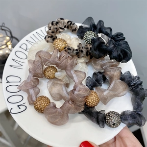 Mesh hair scrunchies with rhinestone balls in beige, grey, black, and leopard print