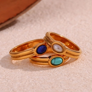 Three 18K gold plated stainless steel rings with colorful natural stones on beige surface