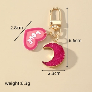 Detail view of pink resin heart and moon keychain with LOVE text and dimensions