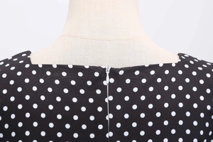 Detail shot of invisible back zipper and retro polka dot fabric texture on the dress