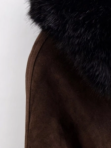 Close-up of brown suede jacket texture and premium black faux fur collar detail