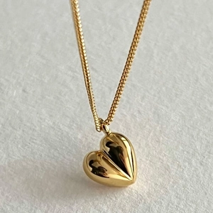 Minimalist 925 sterling silver heart necklace with glossy golden pendant finish