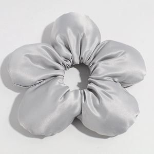 Detailed macro view of silver grey oversized satin floral hair tie scrunchie with 3D petals