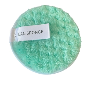 Mint green round microfiber makeup remover sponge with a white Clean Sponge label