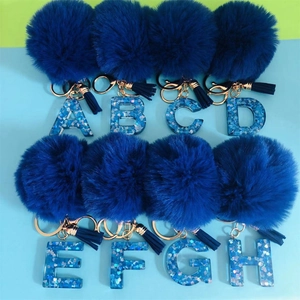 Deep blue pompom initial keychains with resin letters A to H and matching tassels