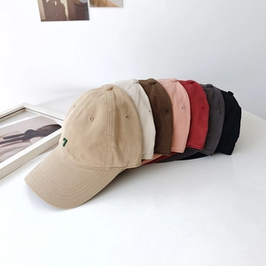 Collection of washed cotton baseball caps in multiple colors featuring a green number 7 embroidery