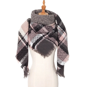 Thick pink and grey herringbone scarf with tassels displayed on a mannequin