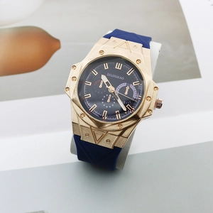 Macro detail of the gold-tone polygonal case with screws and navy chronograph dial