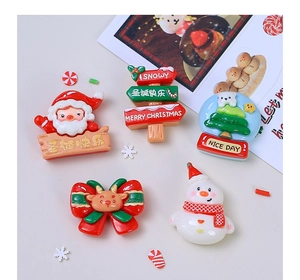 Flat lay of Christmas resin charms featuring Santa, tree, and snowman for DIY accessories