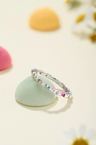 Macro detail of silver ring featuring multi-color rectangular-cut rainbow zircon stones