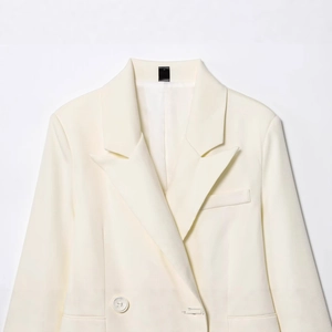 Elegant ivory white double-breasted women blazer with lapel collar on a clean background
