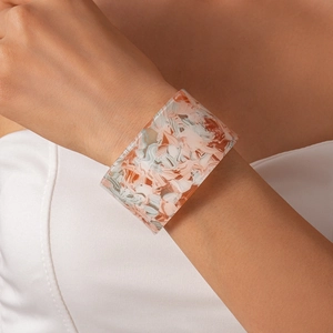 Detail of wide resin bangle featuring abstract oil paint marble texture and artistic colors