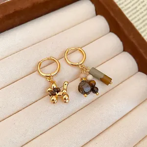 Asymmetric gold-plated dog hoop earrings with tiger eye beads and tassel charms
