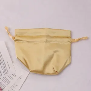 Champagne gold satin drawstring pouch for luxury gift packaging or cosmetic storage