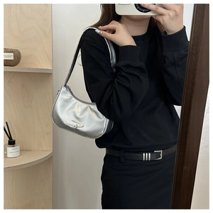 Mirror selfie showing a silver metallic hobo shoulder bag with smooth glossy finish