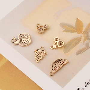 Golden fruit pendants set featuring apple, cherry, grape and watermelon shapes for DIY jewelry