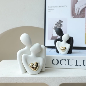 Modern abstract ceramic couple figurines with golden heart decor for home bookshelf