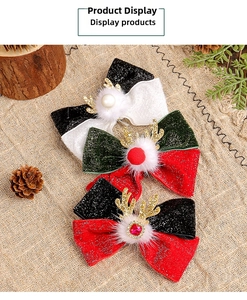 Detail of Christmas reindeer antler hair clips with plush pom-poms and sequin bows