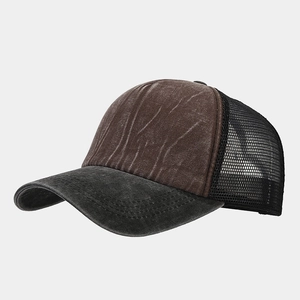 Detail of vintage washed canvas texture and breathable mesh on a trucker cap