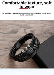 Close-up of braided leather bracelet with metal beads and magnetic clasp on wooden surface