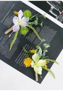 Detail view of handmade lilac and yellow wedding corsages with vintage hemp rope wrapping