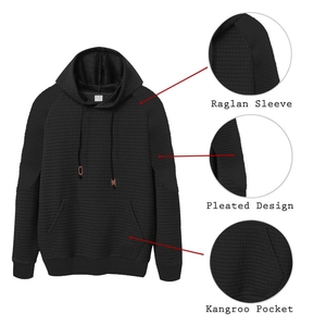 Detail of raglan sleeves, pleated design, and kangaroo pocket on black checkered hoodie