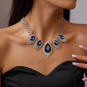 Detail of vintage necklace with large blue teardrop crystals and silver chain