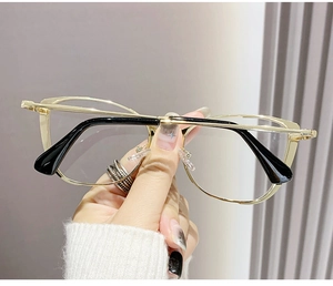 Detailed view of gold metal optical glasses frame with black anti-slip temple tips