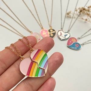 Macro shot of split rainbow heart pendant necklace in gold alloy for best friends