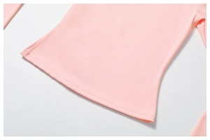 Close-up of fine stitching and smooth elastic fabric on the hem of a pink yoga top