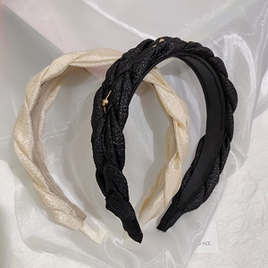 Detail of woven textured headbands with gold heart charms and non-slip inner teeth