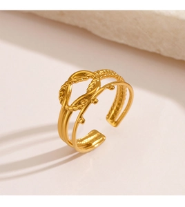 Macro shot of gold plated multi-layer twisted rope ring with adjustable open band