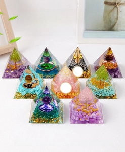 Macro detail of orgone pyramids with crystal stones, tree of life, and copper wire coils