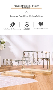 Detailed close-up of iron earring stands with wood bases and gold metal jewelry hangers