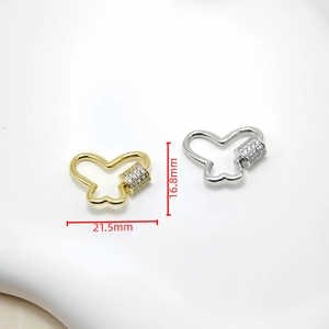 Detail view of butterfly clasps in gold and silver with zircon inlays and dimensions