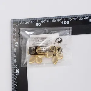 Detail of matte gold layered flower earrings with size scale measurement