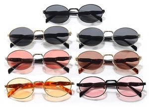 Macro detail of various vintage oval metal sunglasses frames in multiple lens colors