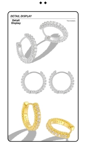 Macro detail of S925 sterling silver hoop earrings with twisted texture and zircon inlay