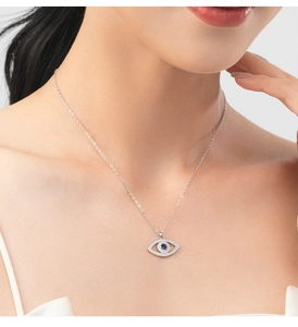 Close-up of S925 silver Evil Eye necklace with blue gemstone and sparkling crystals