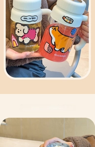 Close-up of high-capacity glass cup featuring cute cartoon dog and cat illustrations
