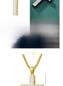 Macro detail of titanium steel cross pendant with gold two-tone diagonal textured carving