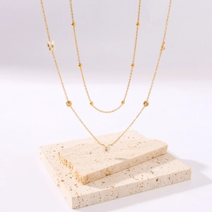 Double-layer 18K gold plated titanium necklace featuring butterfly and diamond pendants