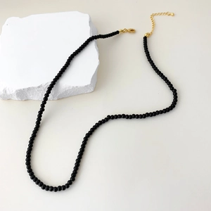 Close-up of black onyx beaded necklace with golden adjustable lobster clasp closure