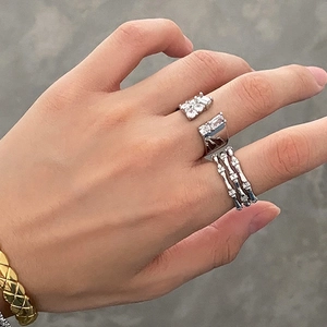 Three-layer zircon ring and silver pavé open ring set worn on model's hand