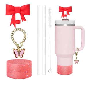Detailed pink tumbler set with red bow straw cover and glitter silicone protective boot
