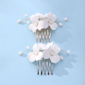 Detail showing gold and silver bridal hair combs with white ceramic flowers and pearls