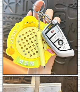 Detail view of yellow duck magnetic steel ball drawing board keychain toy for stress relief.