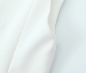 Close-up of the white elastic tank top fabric texture and clean armhole stitching