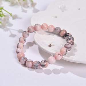 8mm natural pink zebra stone beaded bracelet on white ceramic plate for women